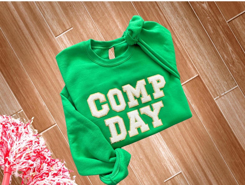 crewneck sweatshirt featuring comp day in white chenille letters