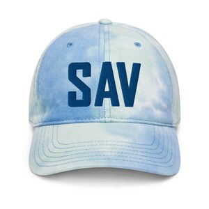 May include: A blue and white tie-dye baseball cap with the word "SAV" embroidered in dark blue on the front.