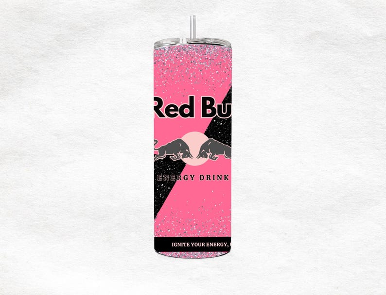 May include: A pink glitter tumbler with the Red Bull logo. The tumbler features the words "Red Bull" in black, along with the brand's bull logo and the words "ENERGY DRINK". The text "IGNITE YOUR ENERGY" is also visible.