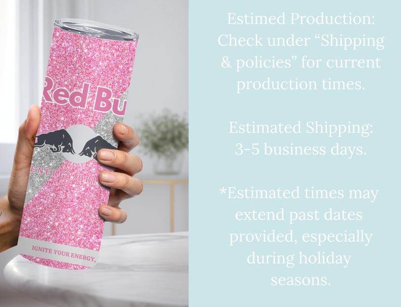 May include: A pink glitter tumbler featuring the Red Bull logo in white and black. The tumbler has the text "Red Bu" and "IGNITE YOUR ENERGY" printed on it. The tumbler is held by a person's hand.