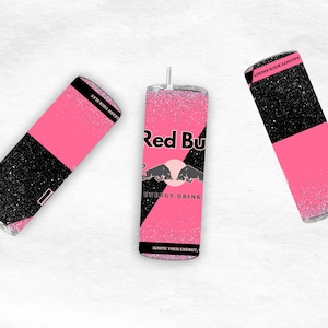 May include: Three glitter-covered tumblers with a pink and black design. One tumbler features the Red Bull logo and text, while the others have text that reads "LEASH YOUR SLAY" and "NAUGHTY BITCH ENERGY".