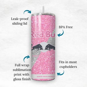 May include: A pink glitter tumbler with the Red Bull logo. The tumbler has a leak-proof sliding lid and is BPA-free. The design includes a full wrap sublimation print with a gloss finish. The text "IGNITE YOUR ENERGY" is visible.