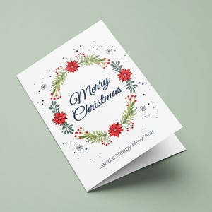 May include: A white greeting card featuring a circular wreath of green leaves, red berries, and red poinsettia flowers. The text Merry Christmas is printed in dark blue script in the center, with the text ...and a Happy New Year below.