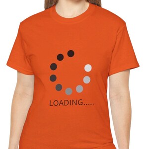 May include: Orange t-shirt featuring a graphic of a loading circle and the text "LOADING..."