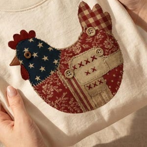 May include: A white ceramic mug with a black handle and the text "But First, Coffee" in a bold, black font. The mug is set against a blurred background, suggesting a cozy setting.