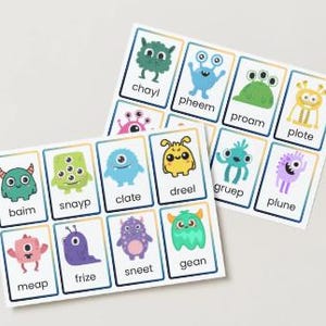 May include: Two sets of flashcards featuring colorful cartoon monsters. Each card has a unique monster illustration and a nonsensical word. The monsters are various colors, including green, blue, yellow, and purple. The cards are arranged on a white surface.