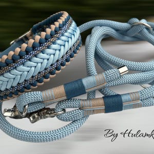May include: A dog collar and leash set in shades of blue and tan. The collar features a braided design with a silver buckle. The leash and collar are made of a sturdy rope material. The text "By Hulamka" is visible.