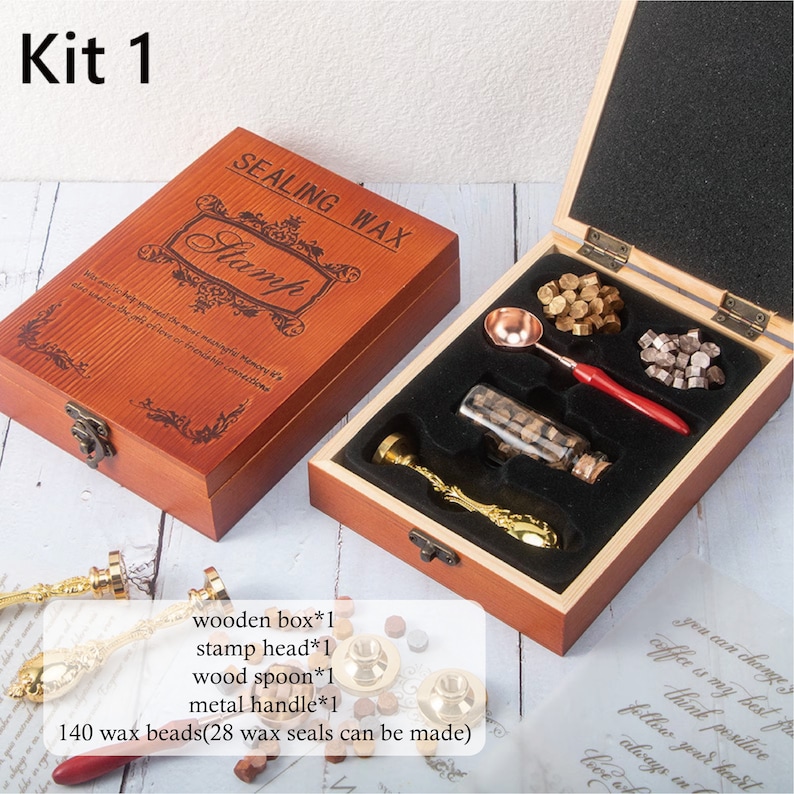 May include: A sealing wax kit in a wooden box labeled Kit 1. The set includes a metal stamp with a gold handle, a melting spoon with a red handle, a glass bottle of wax beads, and loose wax beads. Text on the box reads SEALING WAX Stamp.