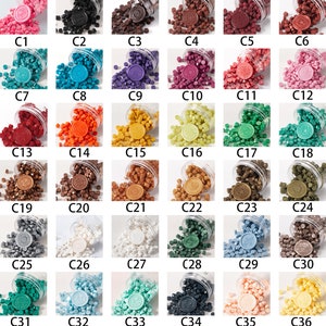 May include: A collection of thirty-six sets of wax seal beads in various colors, each labeled C1 through C36. Each set includes a clear plastic container spilling out small, solid-colored wax beads and a single circular wax seal with a unique design.