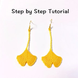 May include: A pair of yellow ginkgo leaf earrings with gold hooks. The earrings are made using a macrame technique.