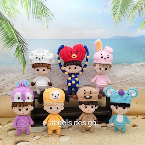 May include: A collection of handmade crochet dolls, each with unique character designs. The dolls feature various colors and styles, including animal-themed hats and outfits. The text "angels design" is visible on the bottom.