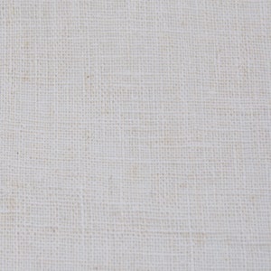 May include: Close-up of a plain, off-white woven fabric with a subtle texture. The fabric has a slightly rough, natural feel.