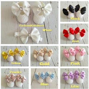 May include: Set of baby shoes with pearl embellishments and satin bows in various colors, including white, black, red, yellow, gold, pink, powder, blue, and lilac.  FashionKidsDress is printed on the image.