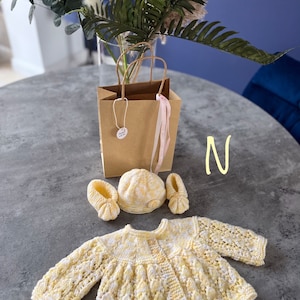 Hand knitted baby cardigan, hat/headband and booties set