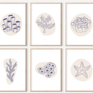 May include: Set of six printable wall art prints featuring illustrations of various sea life, including coral, starfish, and seaweed. The illustrations are in a blue and white color scheme on a beige background.
