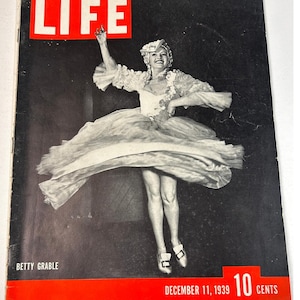 May include: Vintage LIFE magazine cover featuring Betty Grable in a dance pose. The cover has a red banner at the bottom with the date December 11, 1939, and the price 10 cents. The magazine's title, LIFE, is in large white letters.