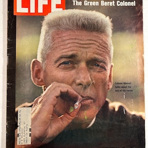 May include: Vintage LIFE magazine cover featuring a portrait of a man smoking. The magazine's title, "LIFE," is in a bold red box. The cover also includes text about astronauts and a colonel, with the date November 14, 1969.
