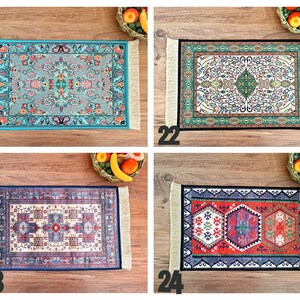 May include: Four different patterned rugs with fringed edges. The rugs are in shades of blue, green, red, and white. The rugs are displayed on a wooden surface.