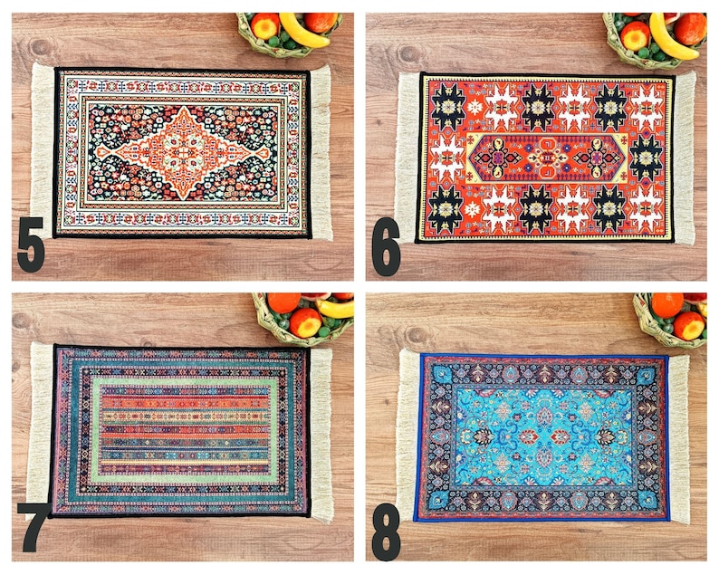 May include: Four colourful patterned rugs with fringed edges. The rugs are displayed on a wooden surface.