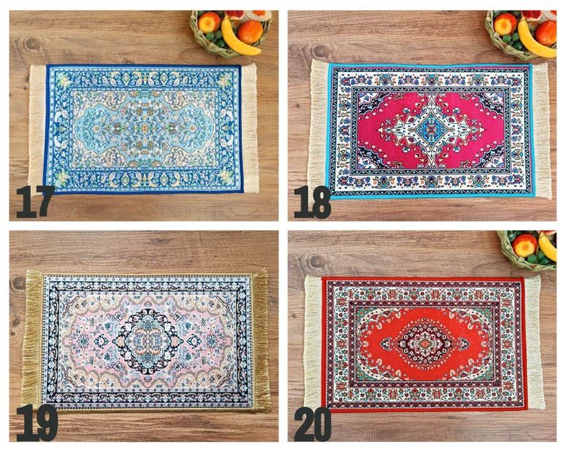 May include: Four different patterned rugs with fringed edges. The rugs are blue, red, pink, and red with a white border. The rugs are all on a wooden surface.