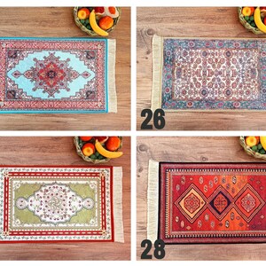 May include: Four different styles of decorative rugs with fringe edges. The rugs are all rectangular and feature intricate patterns in various colors, including red, blue, green, and gold.