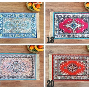 May include: Four different patterned rugs with fringed edges. The rugs are blue, red, pink, and orange. The rugs are all the same size and shape.