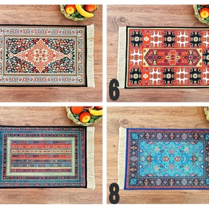 May include: Four colorful patterned rugs with fringed edges. The rugs are displayed on a wooden surface with fruit bowls in the background.