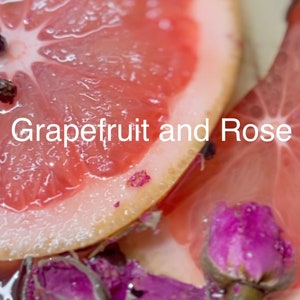 May include: Close-up of a grapefruit and rose petals in a bowl. The grapefruit is sliced in half and the petals are pink and white. The text "Grapefruit and Rose" is visible in the image.