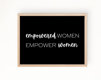 May include: Black and white framed print with the text "empowered women EMPOWER women" in a handwritten font.