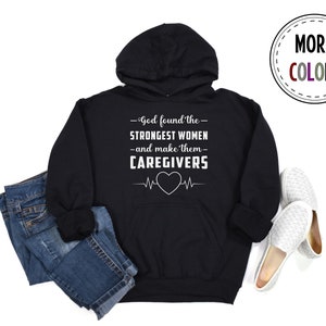 May include: Black hooded sweatshirt with a white graphic that reads "God found the strongest women -and make them- caregivers" with a heart and EKG line.