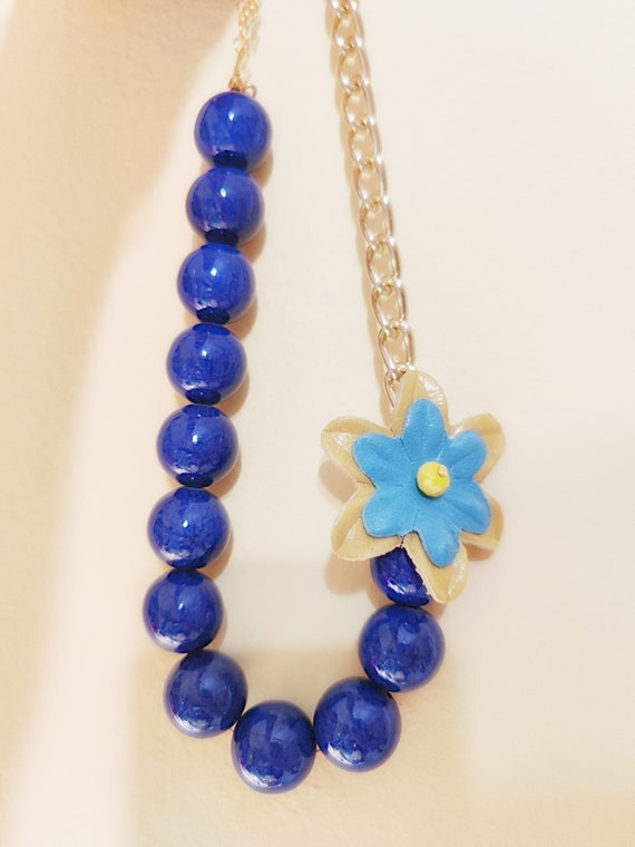 Blue leather flowers necklace.