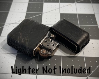 May include: Black leather case for a lighter. The case is open and the lighter is not included.  Lighter Not Included.