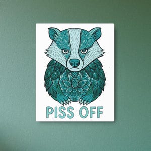 May include: A teal blue badger with a mandala pattern on its body. The badger has a grumpy expression and the text "PISS OFF" is written below it.
