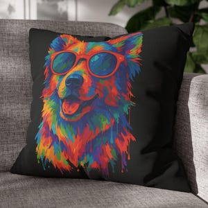 May include: Black square throw pillow featuring a colorful, stylized dog portrait. The dog wears red sunglasses and is rendered in vibrant hues of blue, orange, yellow, and purple. The design has a paint-drip effect.
