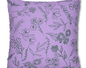 May include: A lavender-colored throw pillow with a floral pattern in dark green. The pillow features a repeating pattern of various flowers and leaves.