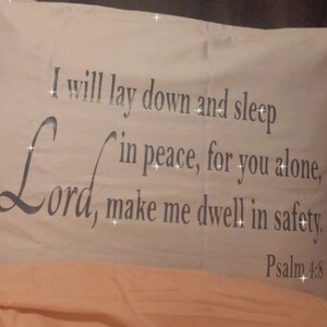 May include: White pillow with the text "I will lay down and sleep in peace, for you alone, Lord, make me dwell in safety. Psalm 4:8" printed on it.