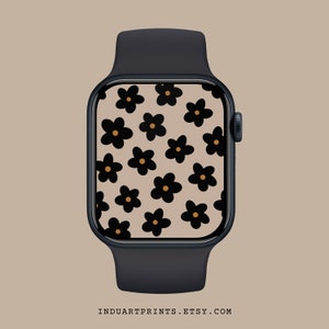 Könnte beinhalten: Eine schwarze Smartwatch mit einem weißen Zifferblatt, das mit einem Muster aus schwarzen Blumen mit orangefarbenen Zentren verziert ist.