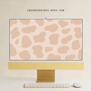 May include: A gold desktop computer with a white keyboard and mouse. The computer screen displays a digital wallpaper with a pattern of abstract beige shapes on a light beige background.