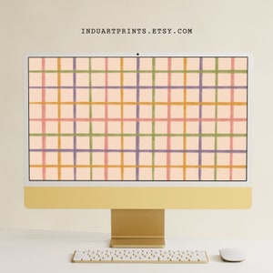 Könnte beinhalten: Ein goldener Desktop-Computer mit einem hellrosa Hintergrund auf dem Bildschirm. Der Hintergrund hat ein Muster aus orangefarbenen, grünen und violetten Linien, die ein Gitter bilden.