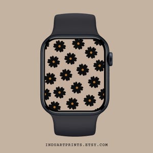 Könnte beinhalten: Eine schwarze Apple Watch mit einem weißen Zifferblatt mit einem Muster aus schwarzen und orangefarbenen Blumen.