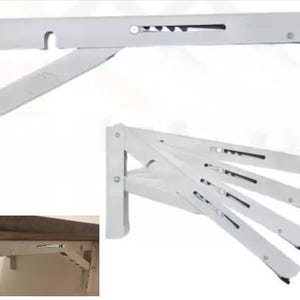 K&ouml;nnte beinhalten: Wei&szlig;er, zusammenklappbarer, an der Wand montierter W&auml;schest&auml;nder. Der St&auml;nder besteht aus Metall und hat eine Reihe von Klapparmen. Er ist f&uuml;r die Wandmontage konzipiert und kann bei Nichtgebrauch zusammengeklappt werden. Der St&auml;nder wird in ge&ouml;ffneter und geschlossener Position gezeigt.