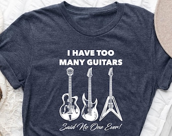 May include: A navy blue t-shirt with the text "I have too many guitars. Said no one ever!" and a graphic of three guitars.