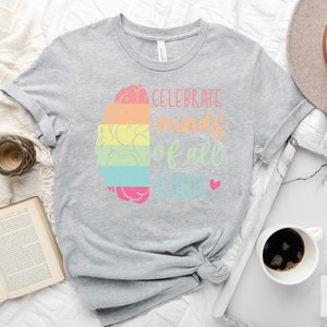 May include: Gray t-shirt with a rainbow brain graphic and the text "Celebrate minds of all kinds".