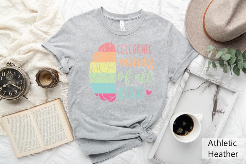 May include: Gray t-shirt with a rainbow brain graphic and the text "Celebrate minds of all kinds".