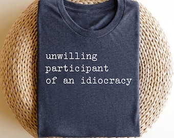Unwilling participant of an idiocracy Political Anti Trump Design | UNISEX Graphic T-Shirt for Women