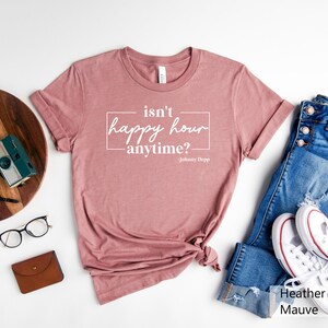 May include: Heather mauve t-shirt with the text "isn't happy hour anytime? - Johnny Depp" printed in white.