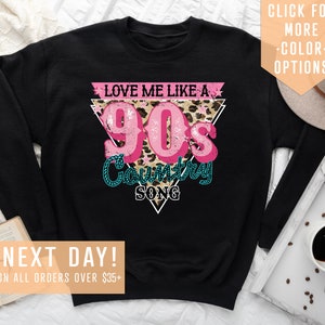 May include: Black sweatshirt with a pink and teal graphic that says "Love me like a 90's Country Song" with a leopard print background.