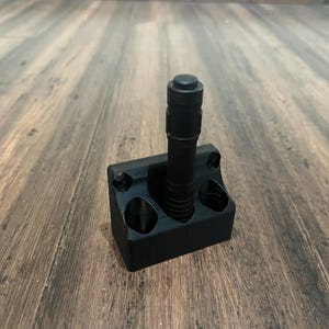 May include: A black plastic wall mount with a single flashlight attached. The mount has two additional slots for flashlights.