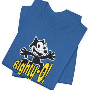 May include: A blue t-shirt with a black and white cartoon cat wearing a yellow hat and the text "Righty-O!" in yellow.