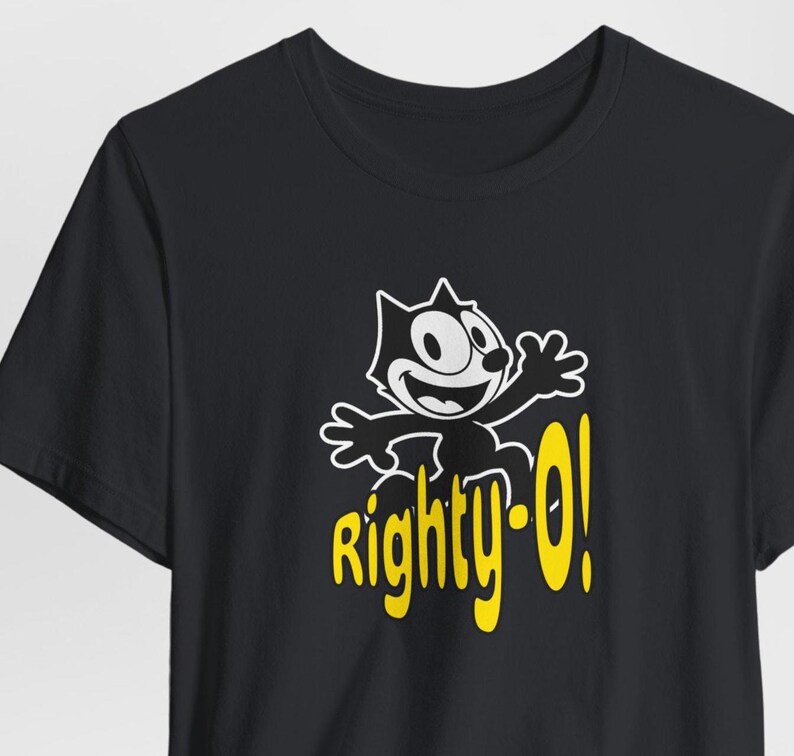 May include: Black t-shirt with a cartoon cat wearing a yellow hat and the text "Righty-O!" in yellow.